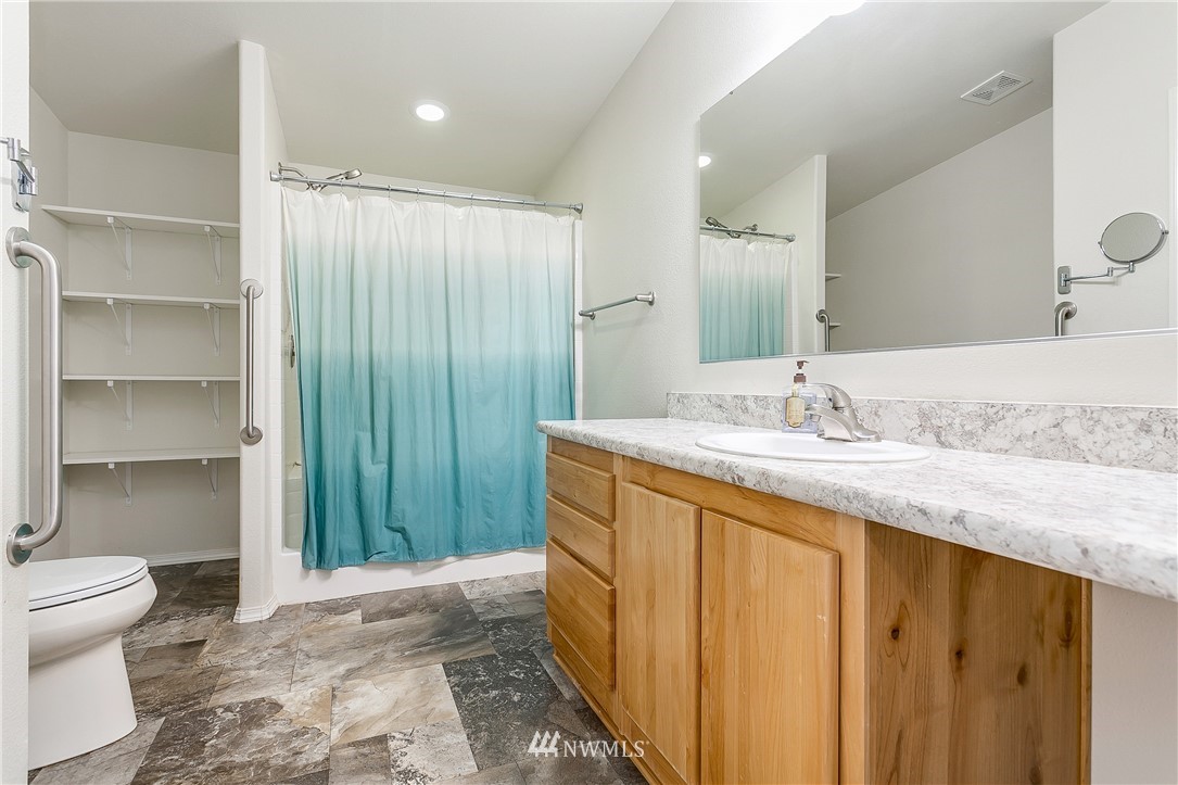 7592 Woodland Road Ferndale, WA 98248 - Photo 20 of 38 a bathroom with a granite countertop sink toilet and shower