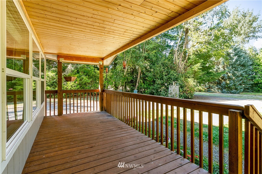 7592 Woodland Road Ferndale, WA 98248 - Photo 3 of 38 a balcony with wooden floor and fence