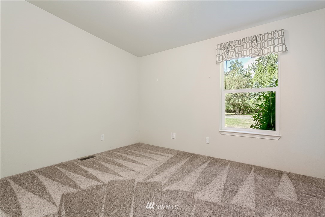 7592 Woodland Road Ferndale, WA 98248 - Photo 23 of 38 a view of a bedroom with a window