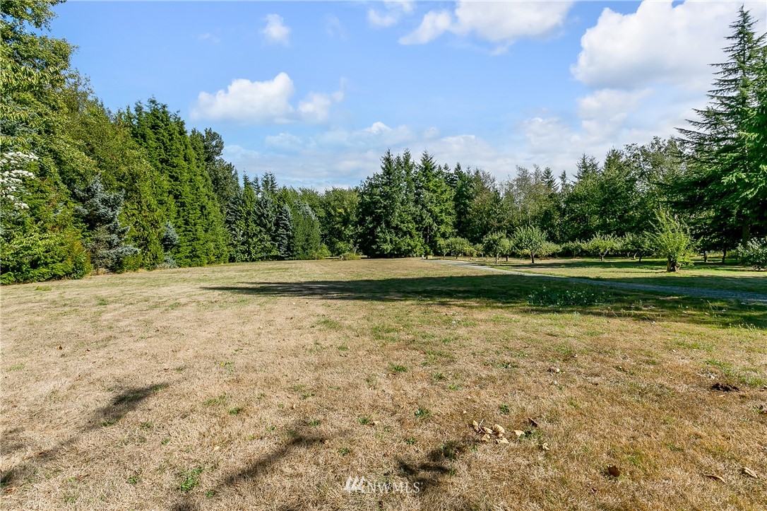 7592 Woodland Road Ferndale, WA 98248 - Photo 24 of 38 a view of outdoor space with swimming pool and trees in the background