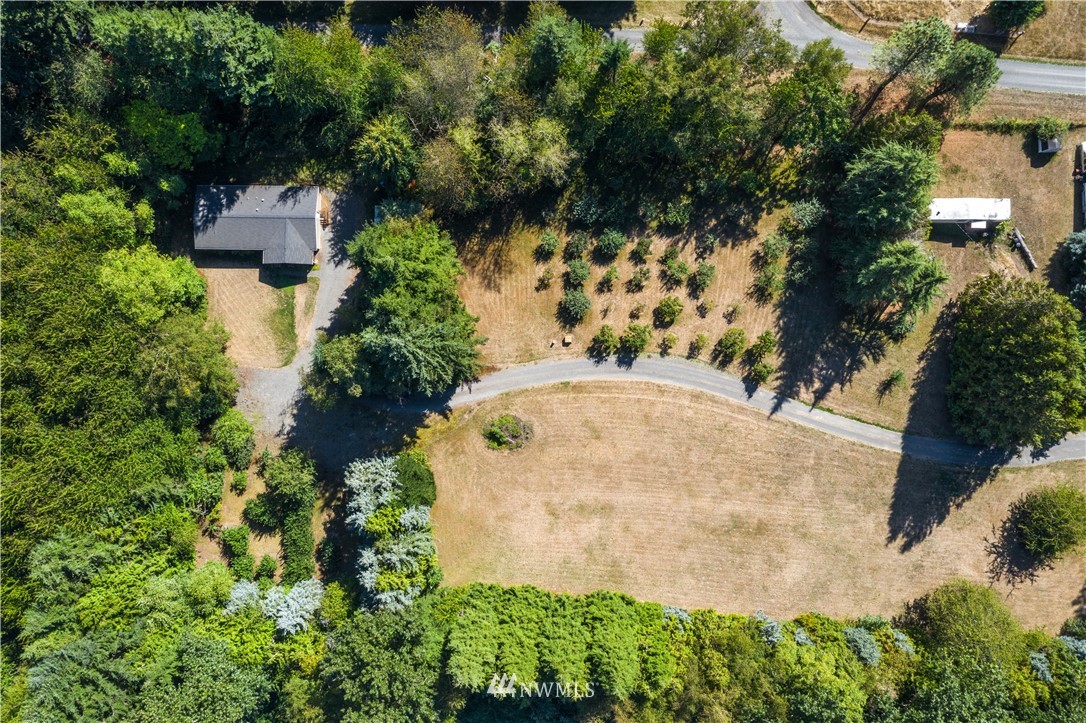 7592 Woodland Road Ferndale, WA 98248 - Photo 28 of 38 an aerial view of a house with a yard and large trees