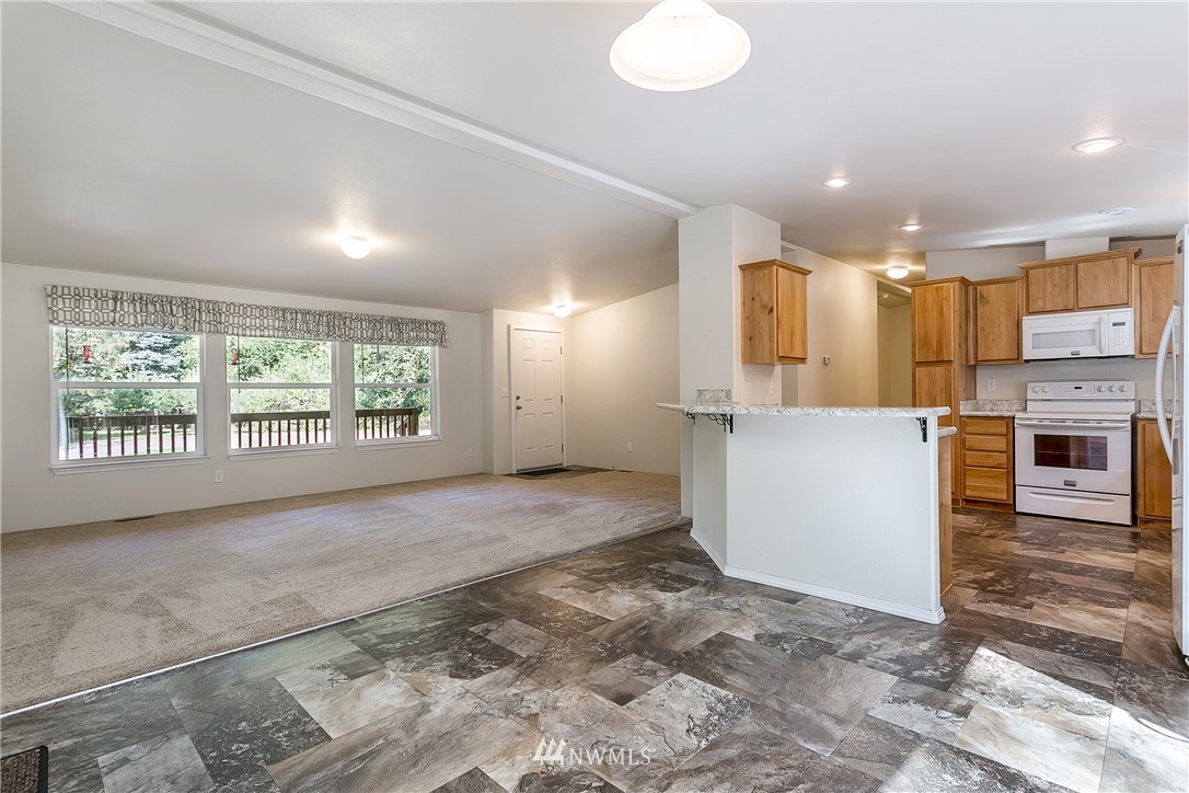 7592 Woodland Road Ferndale, WA 98248 - Photo 5 of 38 a view of a kitchen with a sink and a window