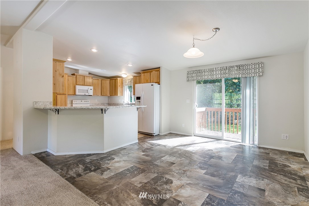 7592 Woodland Road Ferndale, WA 98248 - Photo 6 of 38 a view of a kitchen with refrigerator and cabinets
