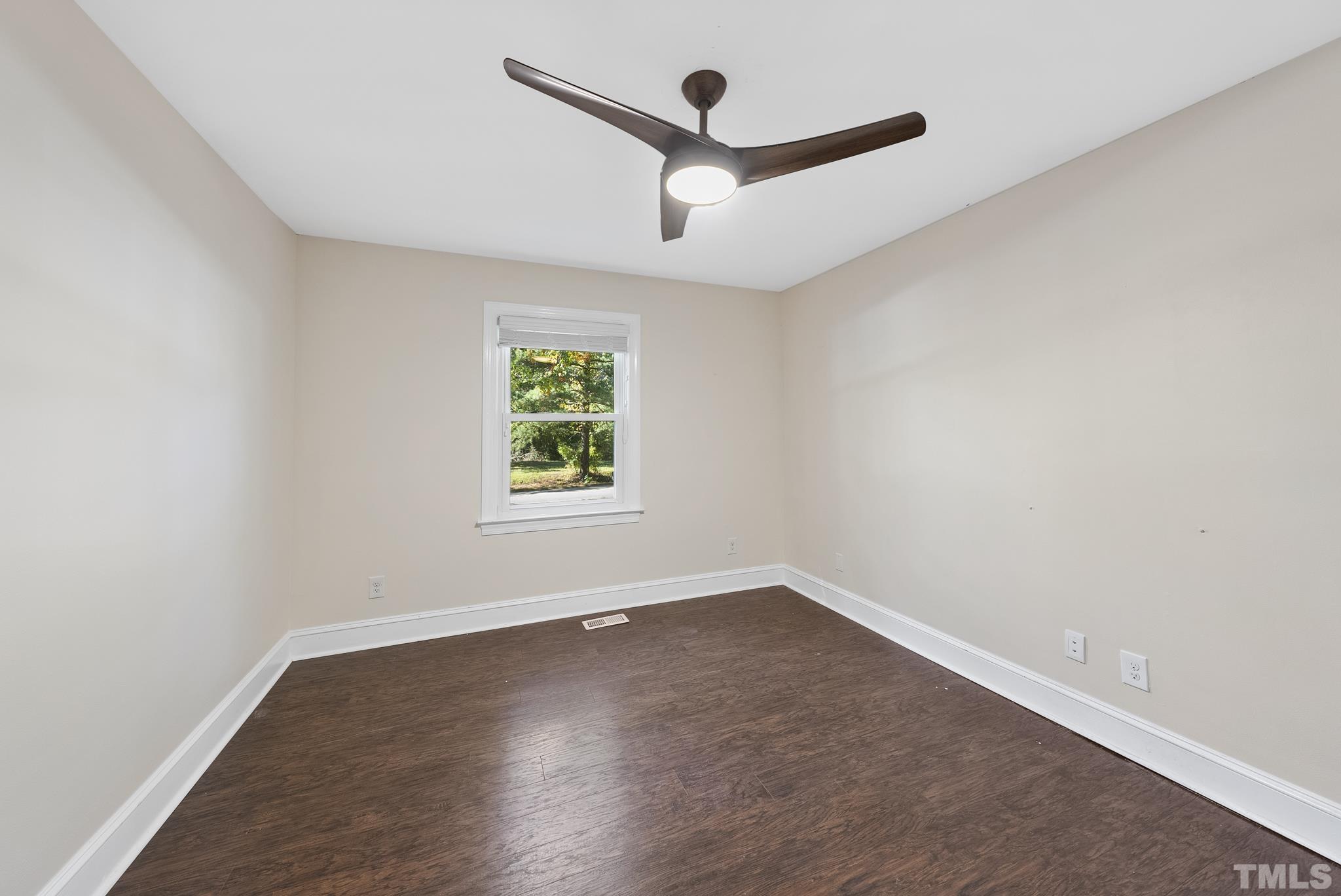 7516 Ray Road Raleigh, NC 27613 - Photo 14 of 23 an empty room with wooden floor and windows