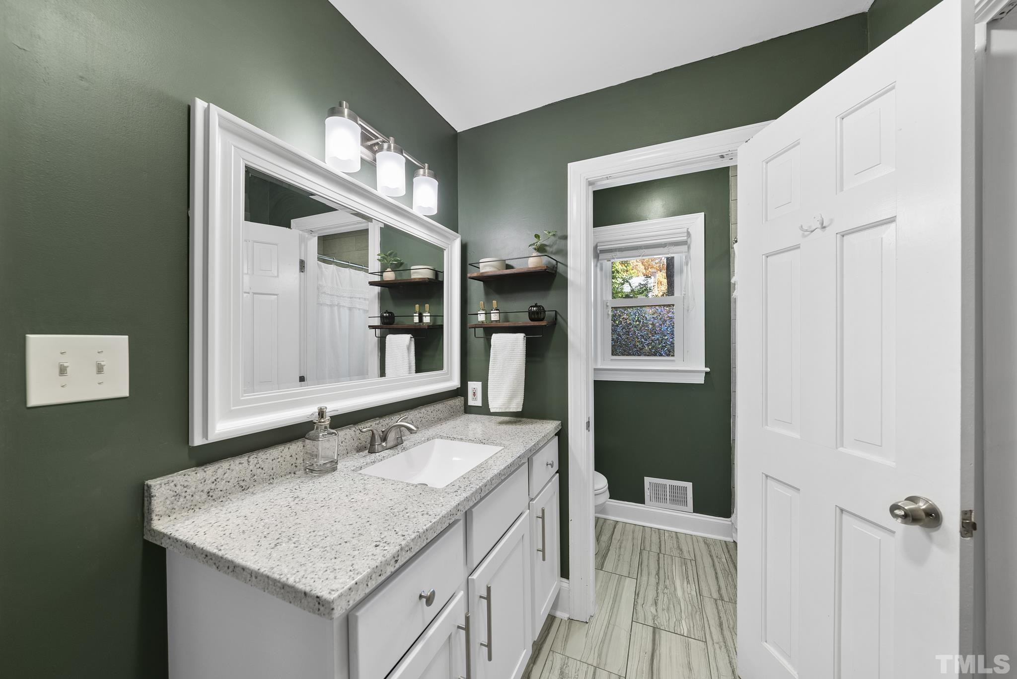 7516 Ray Road Raleigh, NC 27613 - Photo 16 of 23 a bathroom with a sink and a mirror
