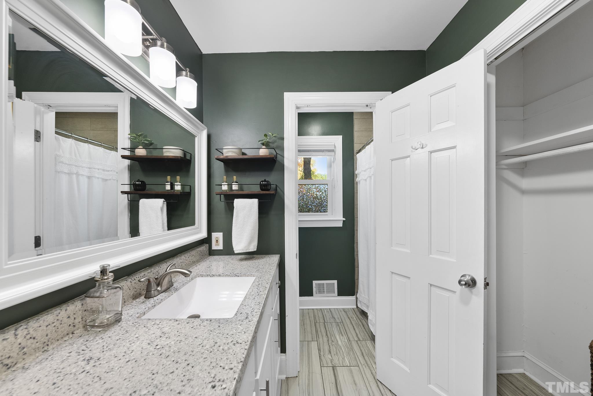 7516 Ray Road Raleigh, NC 27613 - Photo 17 of 23 a bathroom with a granite countertop double vanity sink and a mirror