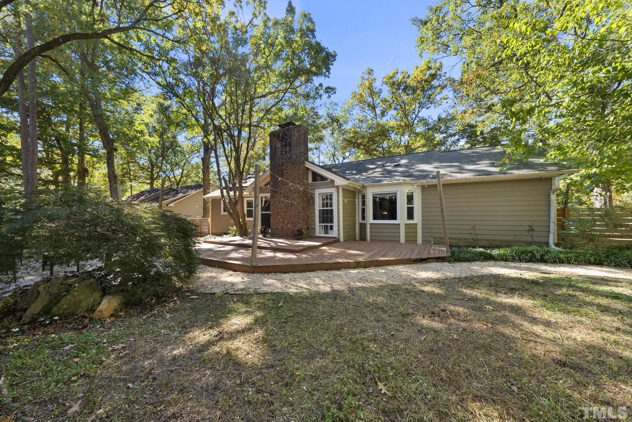 7516 Ray Road Raleigh, NC 27613 - Photo 20 of 23 a view of a house with backyard and trees