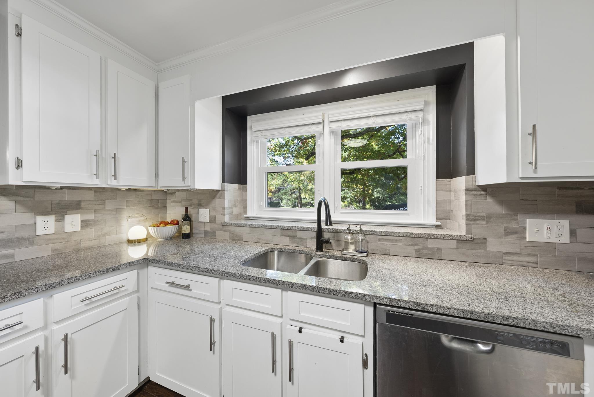 7516 Ray Road Raleigh, NC 27613 - Photo 6 of 23 a kitchen with granite countertop white cabinets and a window