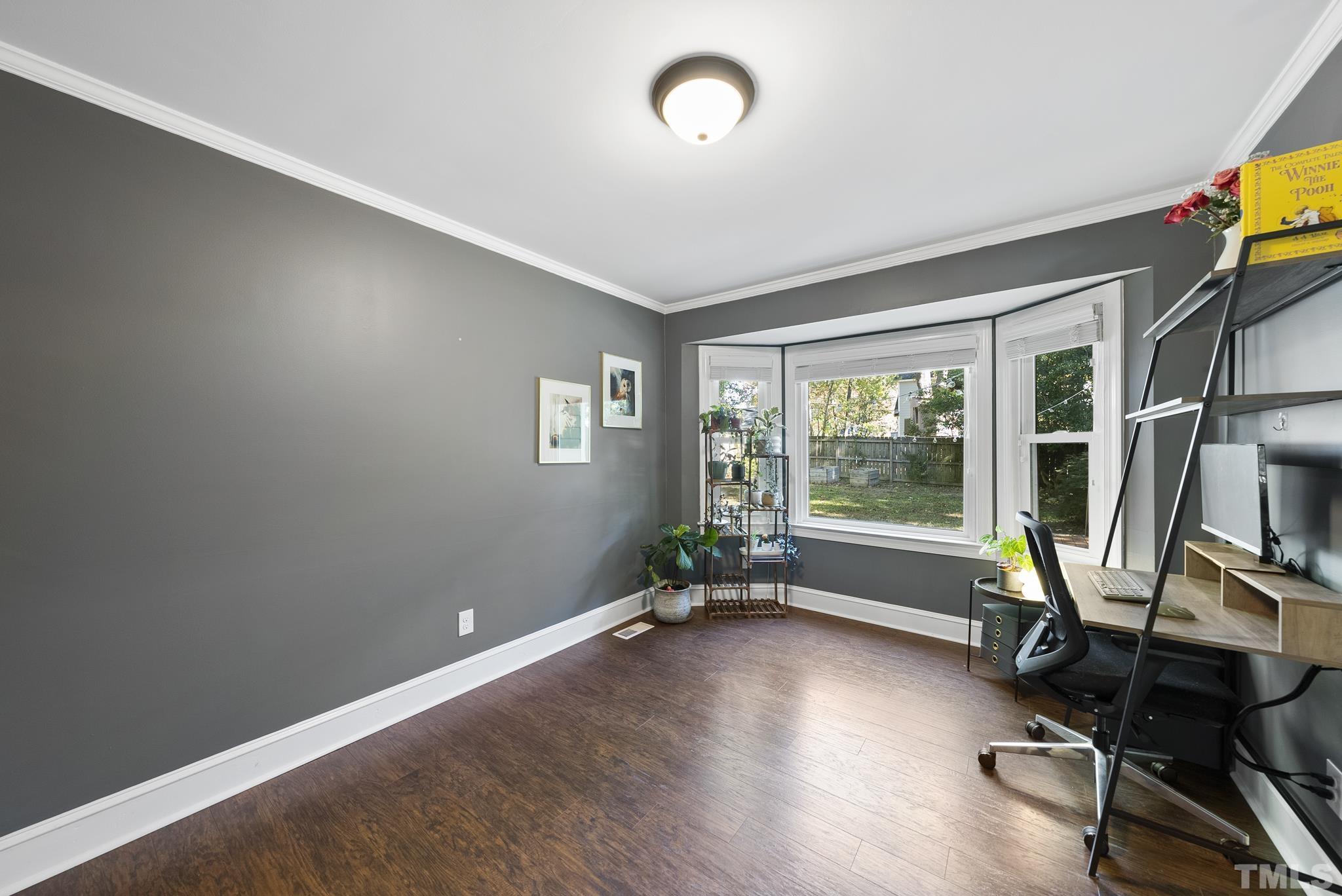 7516 Ray Road Raleigh, NC 27613 - Photo 10 of 23 a view of a workspace with furniture and a window