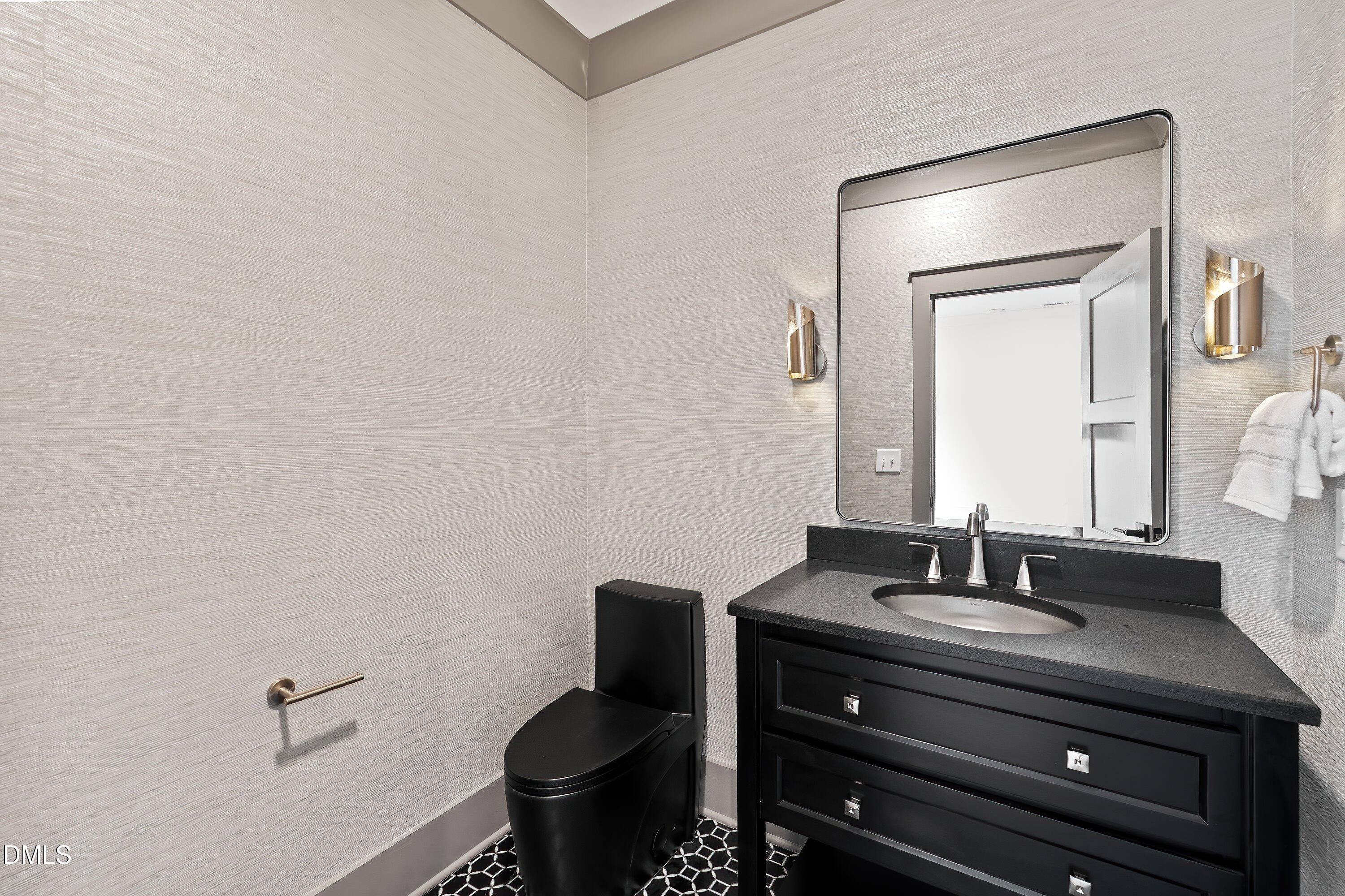 1312 Hunting Ridge Road Raleigh, NC 27615 - Photo 67 of 95 a bathroom with a sink and a mirror