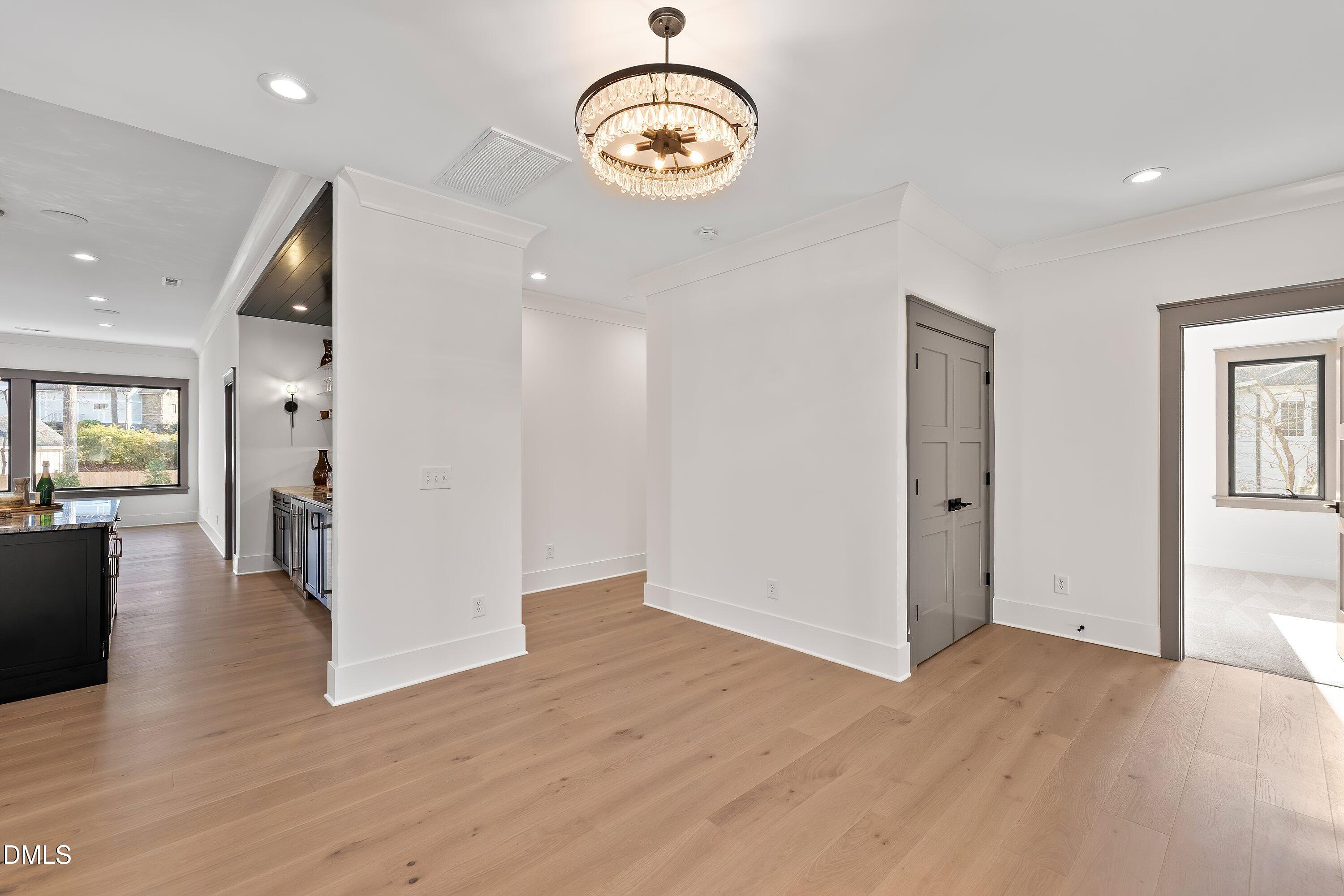 1312 Hunting Ridge Road Raleigh, NC 27615 - Photo 69 of 95 an empty room with wooden floor and windows