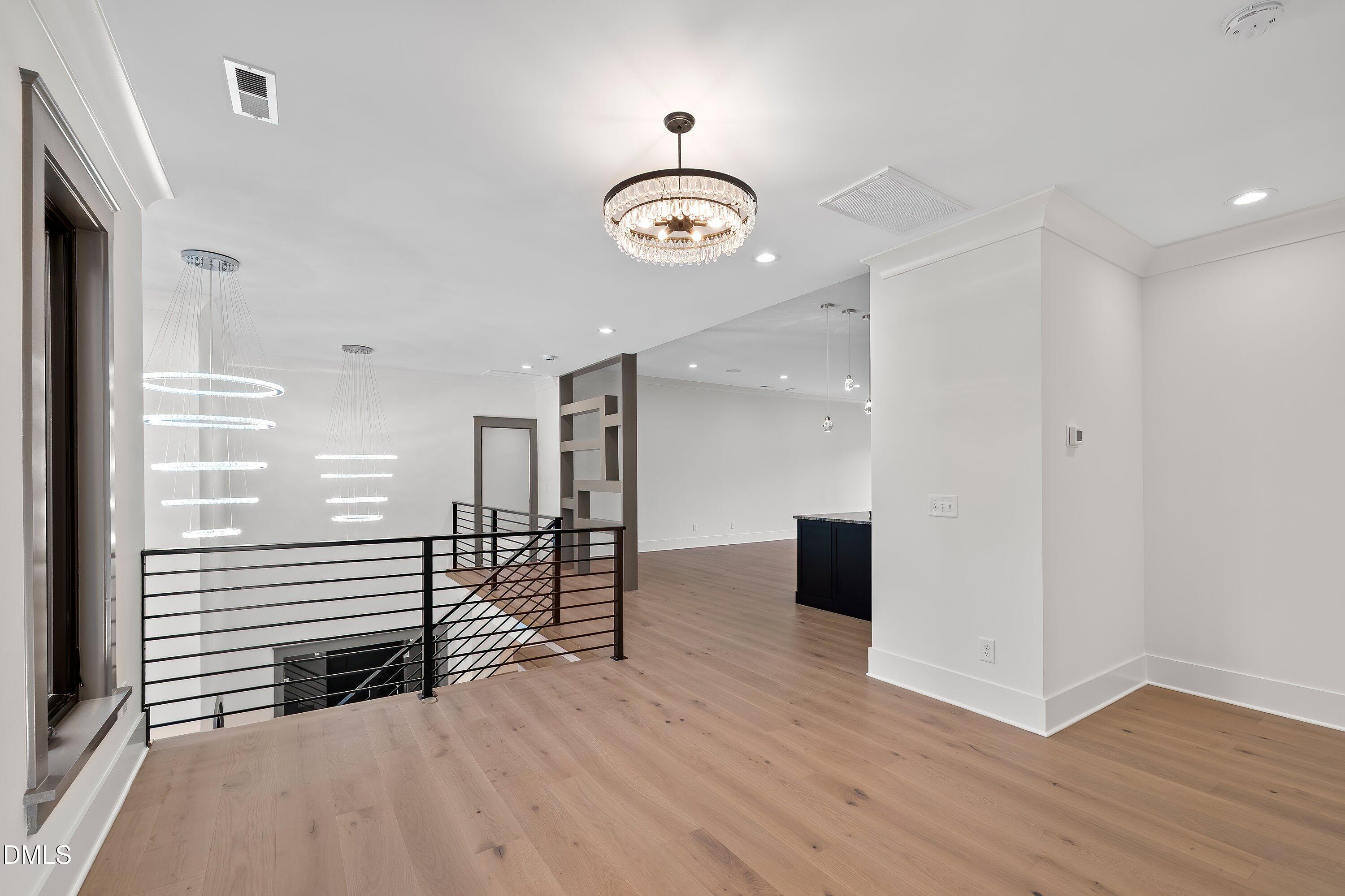 1312 Hunting Ridge Road Raleigh, NC 27615 - Photo 70 of 95 wooden floor in an empty room with a window