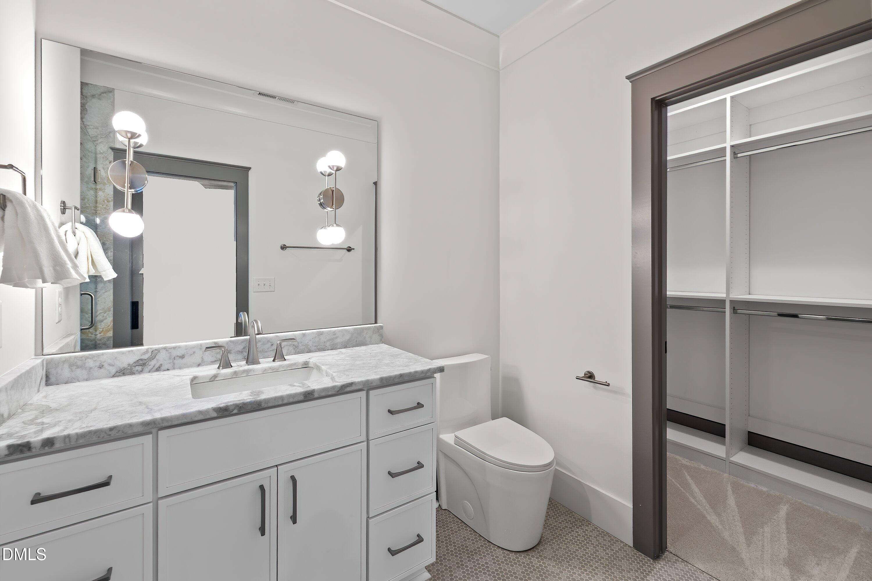1312 Hunting Ridge Road Raleigh, NC 27615 - Photo 78 of 95 a bathroom with a granite countertop sink toilet and shower