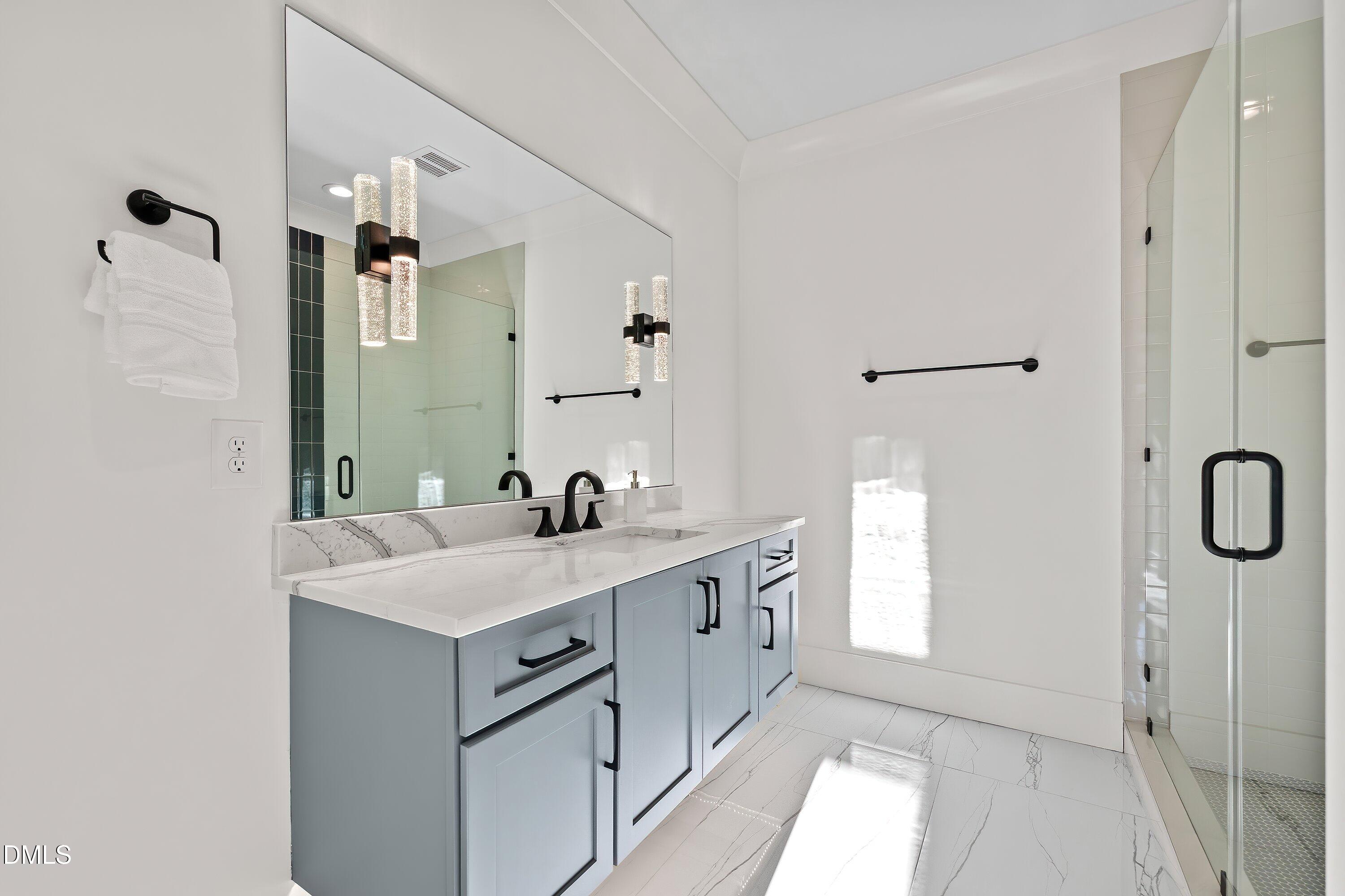 1312 Hunting Ridge Road Raleigh, NC 27615 - Photo 83 of 95 a bathroom with a sink and mirror with shower