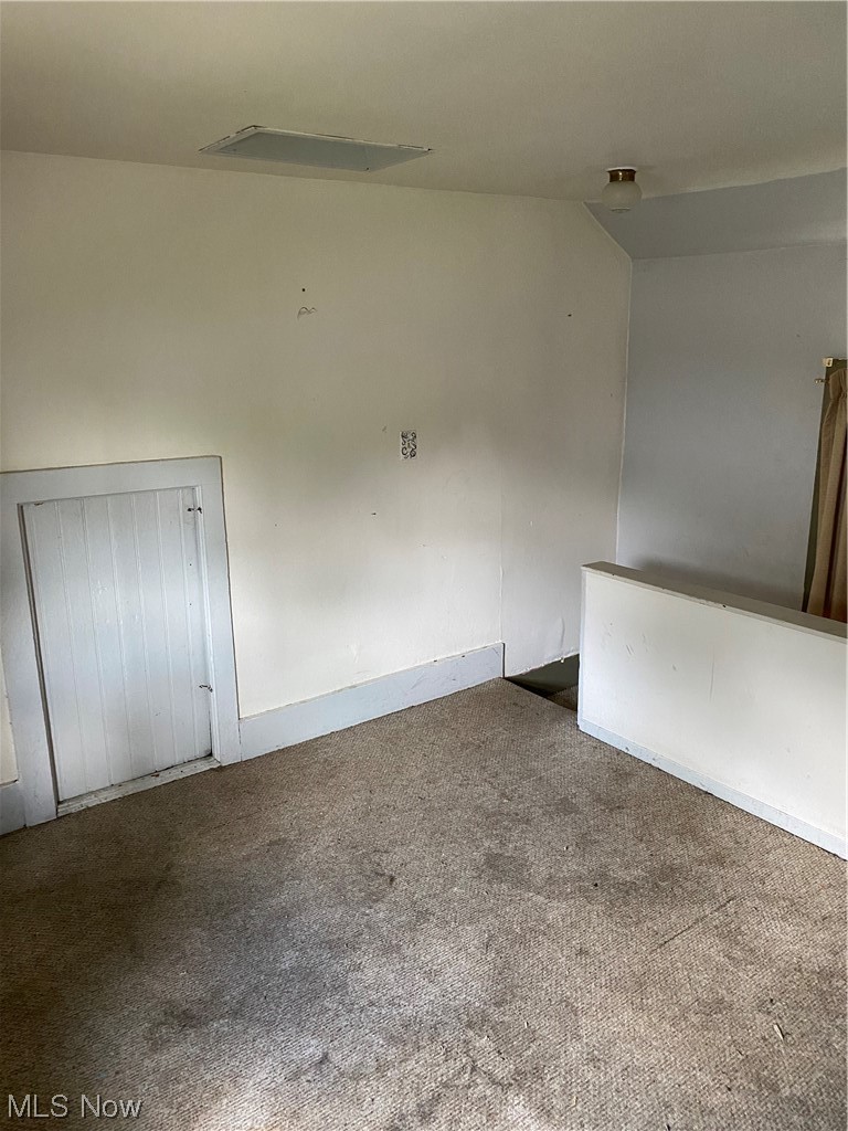 1309 West Prospect Road Ashtabula, OH 44004 - Photo 12 of 17 Unfurnished room featuring lofted ceiling and carpet flooring