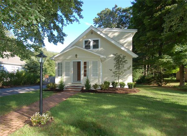 15 Woodland Road Wellesley, MA 02481 - Photo 1 of 5 a front view of a house with a yard
