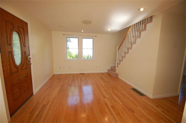 15 Woodland Road Wellesley, MA 02481 - Photo 4 of 5 a view of empty room with wooden floor and fan
