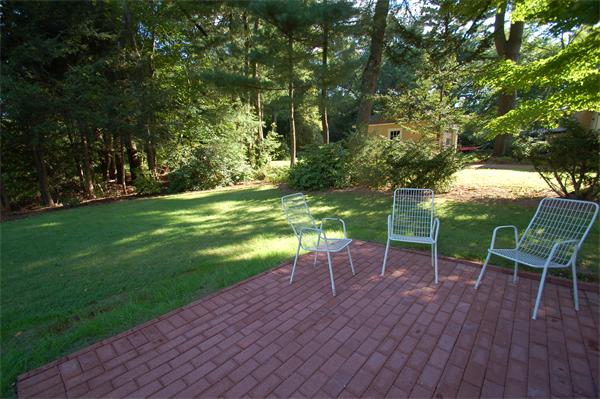 15 Woodland Road Wellesley, MA 02481 - Photo 5 of 5 a view of a table and chairs in the garden