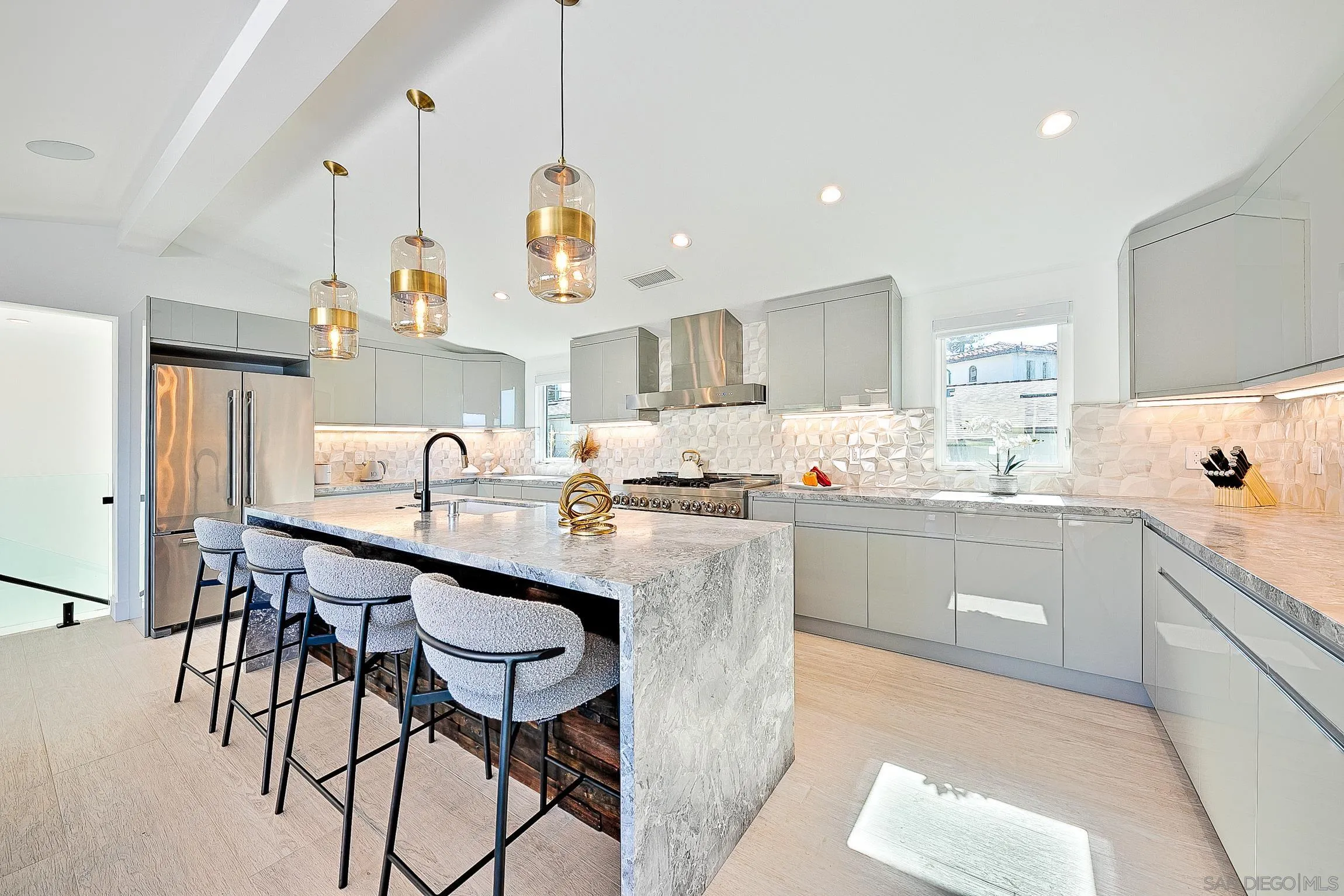 303 Sea Lane La Jolla, CA 92037 - Photo 14 of 61 a kitchen with kitchen island granite countertop a sink a center island and cabinets
