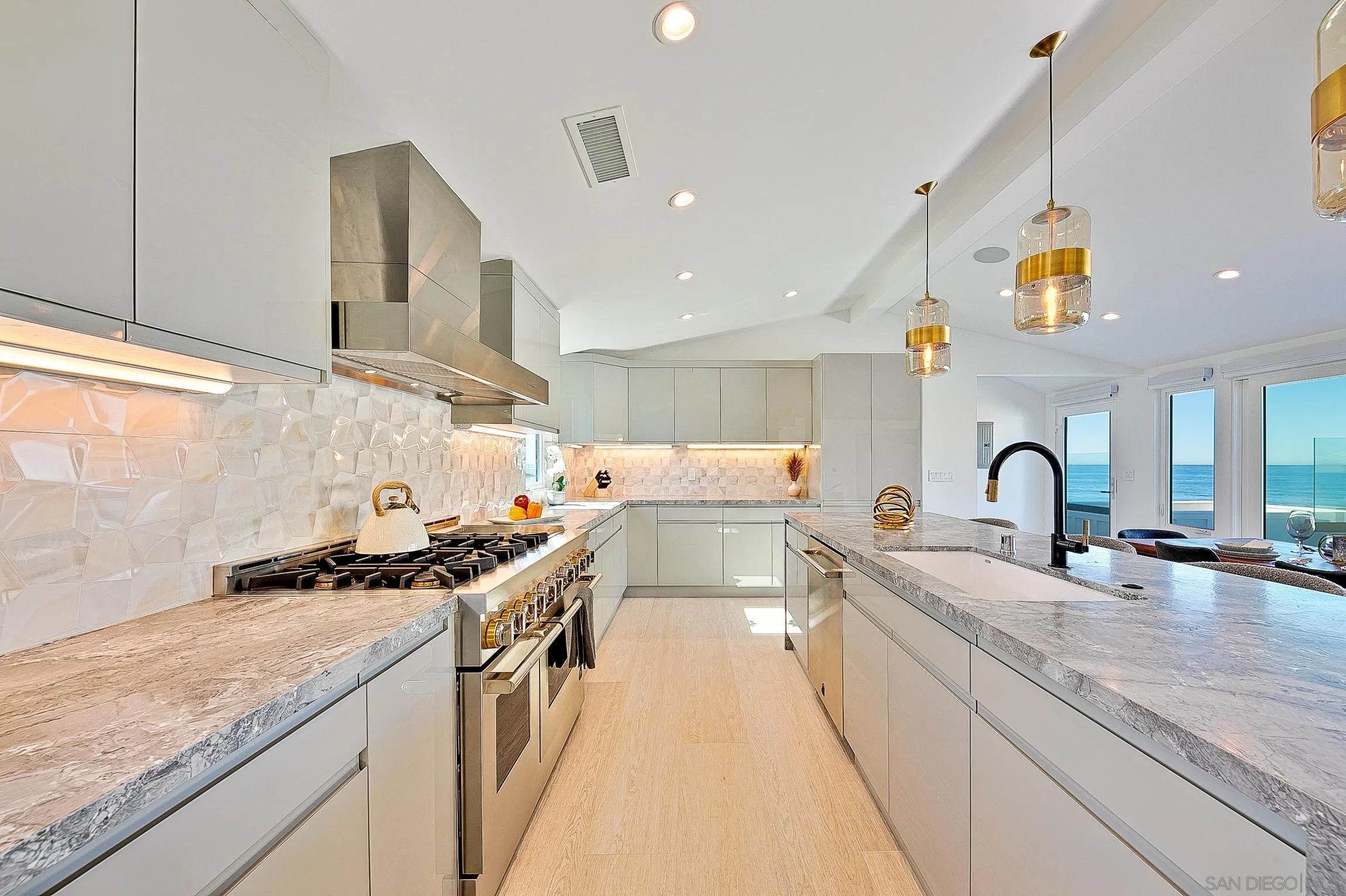 303 Sea Lane La Jolla, CA 92037 - Photo 15 of 61 a kitchen with stainless steel appliances granite countertop a sink stove and cabinets