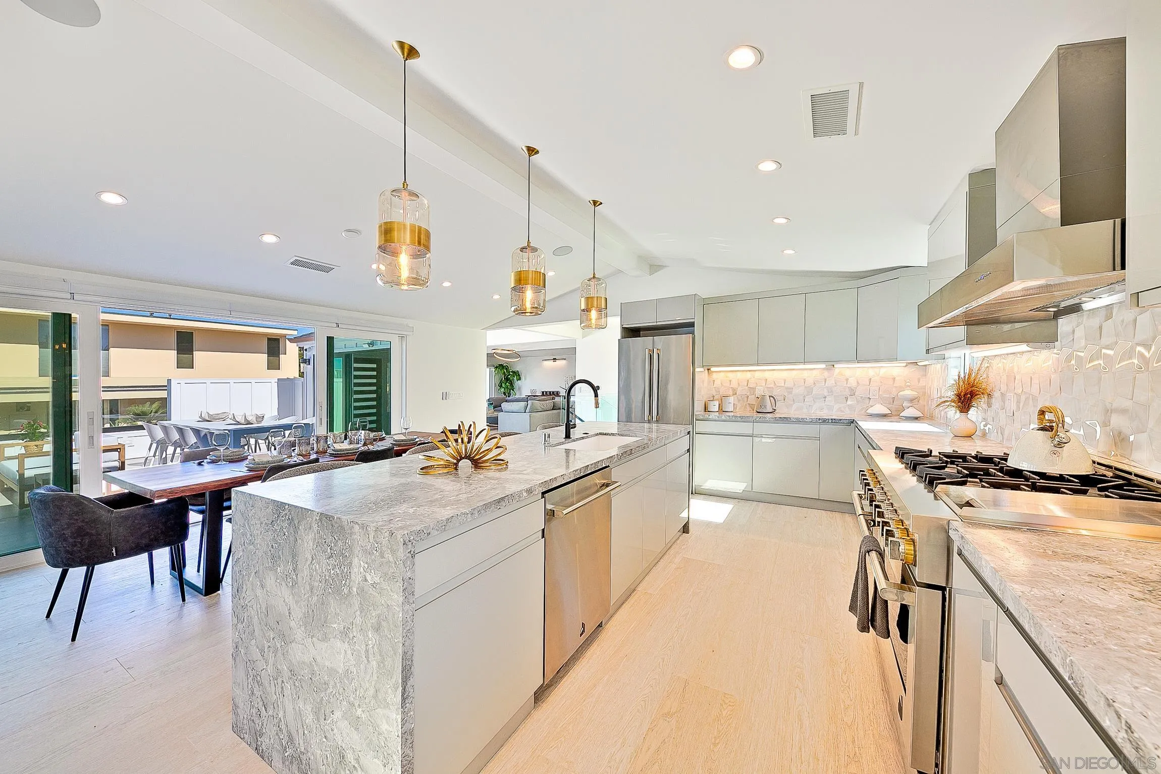 303 Sea Lane La Jolla, CA 92037 - Photo 16 of 61 a kitchen with sink stove and cabinets