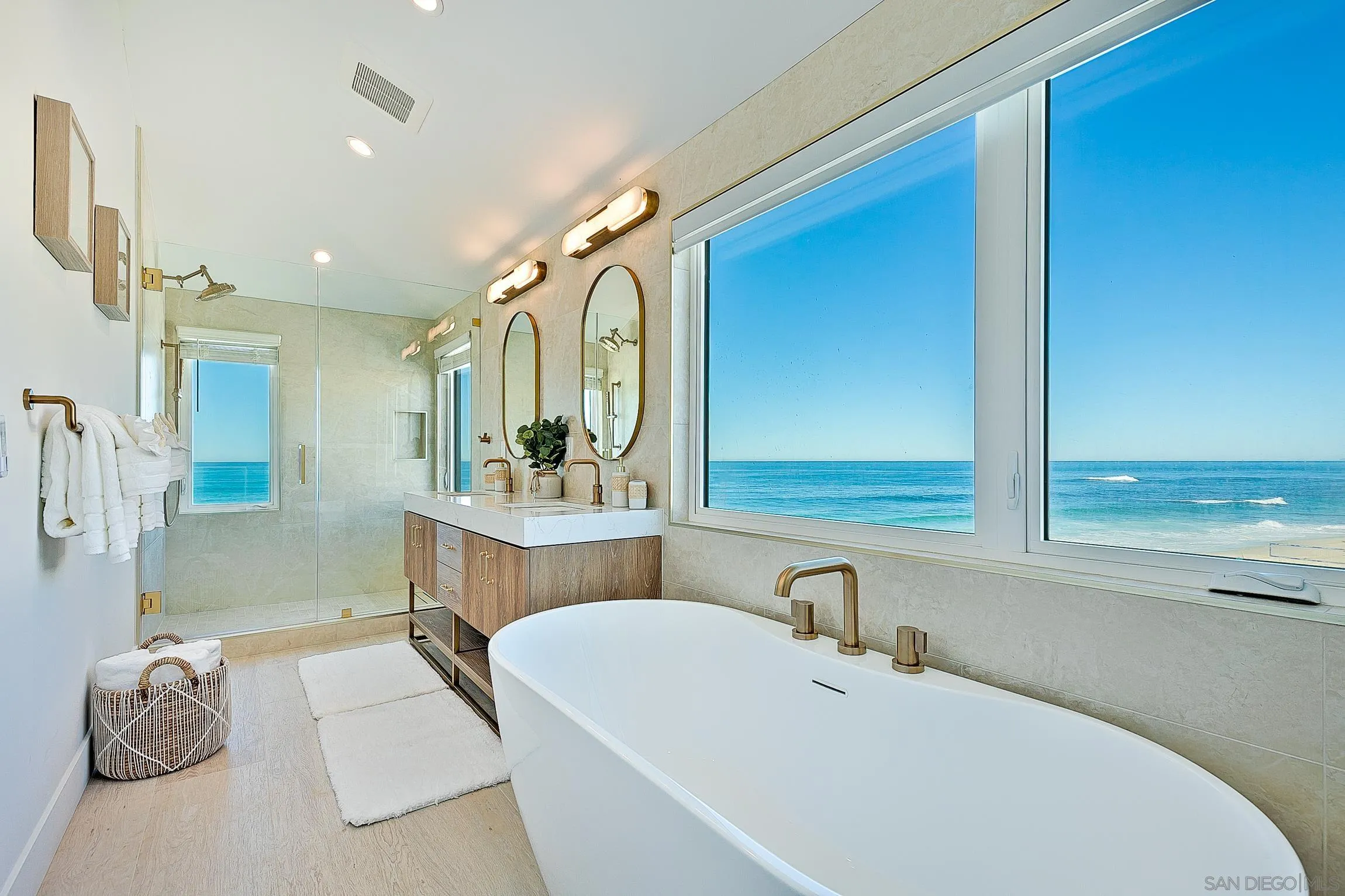 303 Sea Lane La Jolla, CA 92037 - Photo 23 of 61 a bathroom with a bathtub sink and mirror
