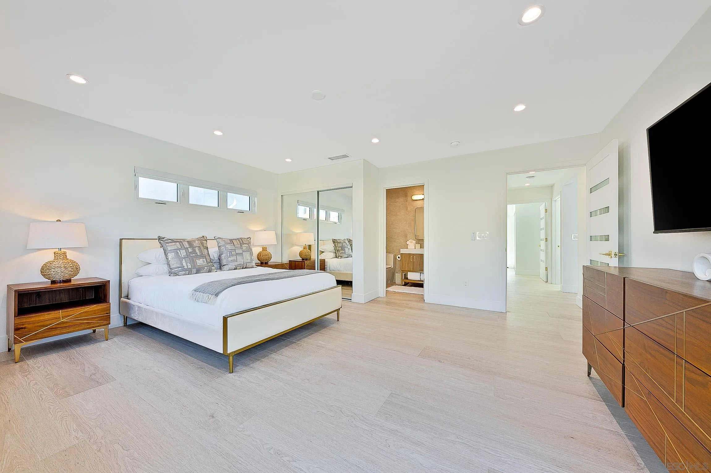 303 Sea Lane La Jolla, CA 92037 - Photo 31 of 61 a spacious bedroom with a bed and a flat screen television