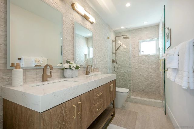 a kitchen with stainless steel appliances granite countertop a sink and a stove