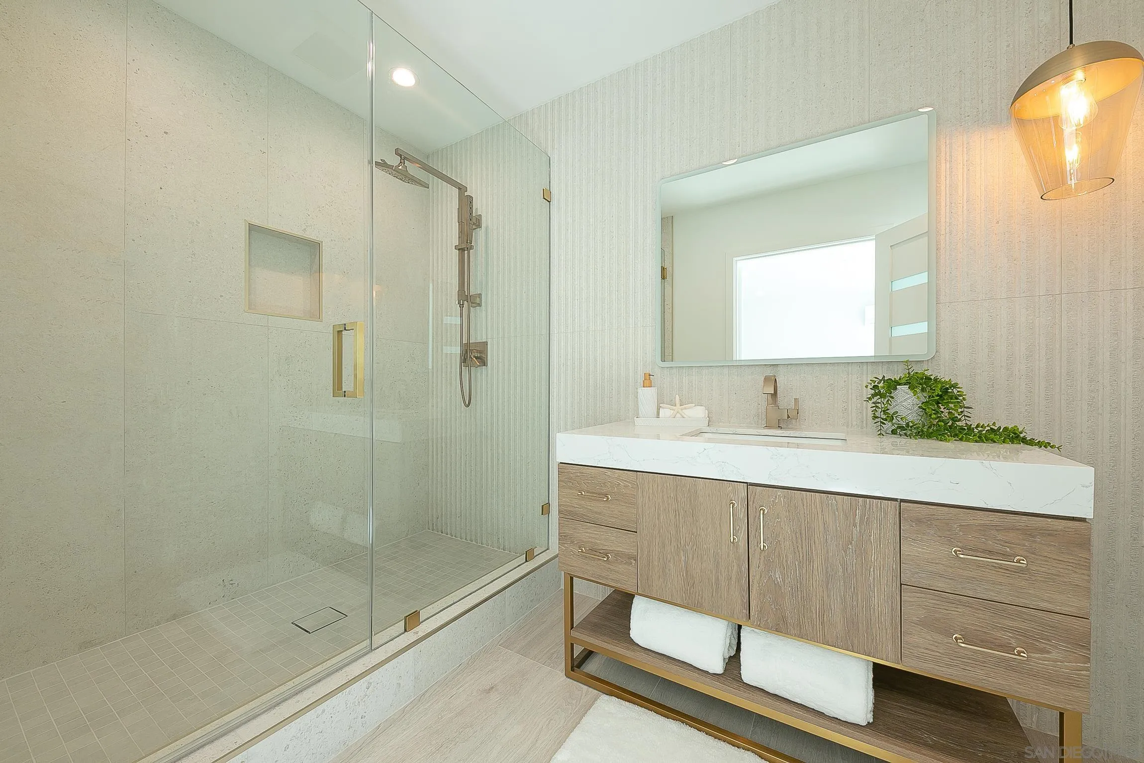 303 Sea Lane La Jolla, CA 92037 - Photo 40 of 61 a bathroom with a shower sink and mirror