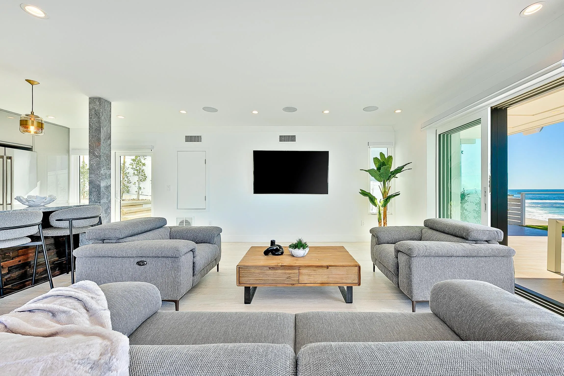 303 Sea Lane La Jolla, CA 92037 - Photo 45 of 61 a living room with furniture and a flat screen tv