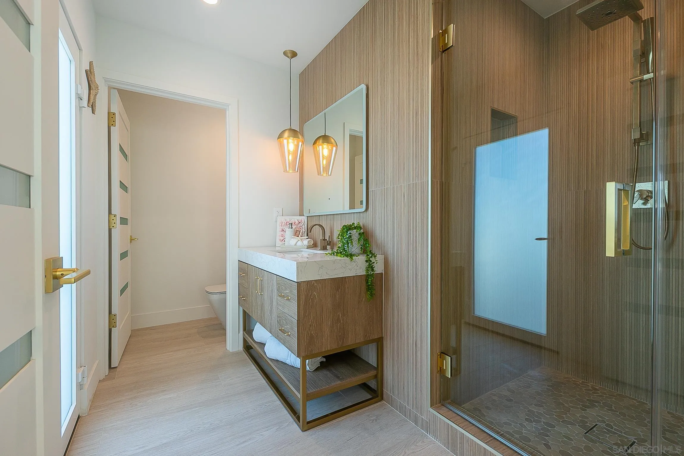 303 Sea Lane La Jolla, CA 92037 - Photo 46 of 61 a bathroom with a double vanity sink and mirror