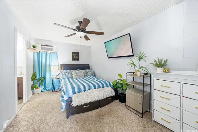 a bedroom with a bed and ceiling fan