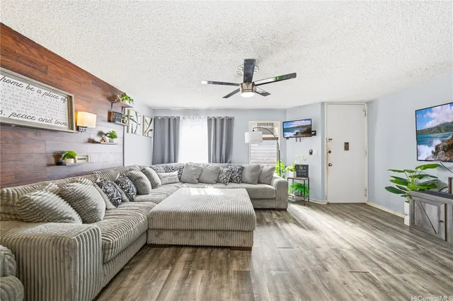 a living room with furniture and a chandelier