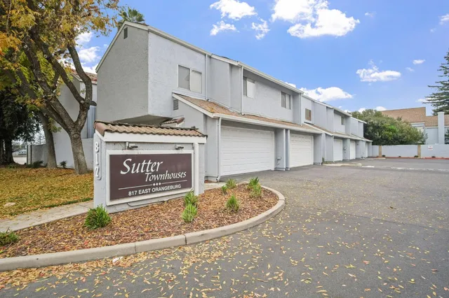 a view of a street sign under a large tree
