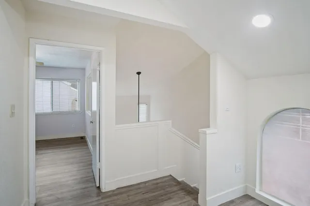 a view of hallway with wooden floor
