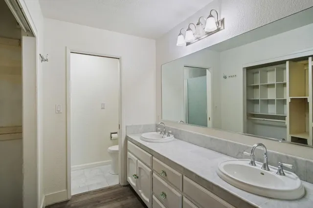 a bathroom with a double vanity sink and a mirror