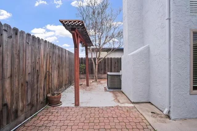 a view of a pathway gate with wooden fence