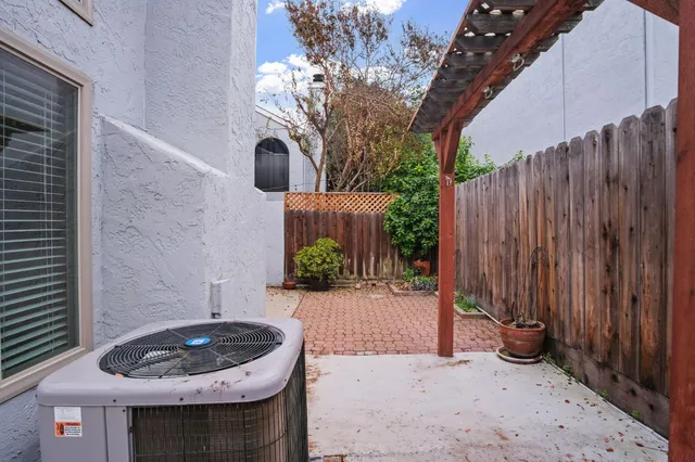 a backyard of a house with barbeque oven and table