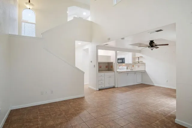 a large white kitchen with a sink