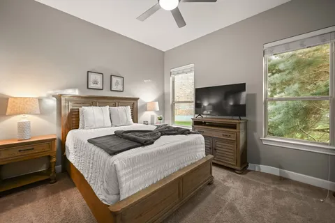 a bedroom with a bed and a flat screen tv