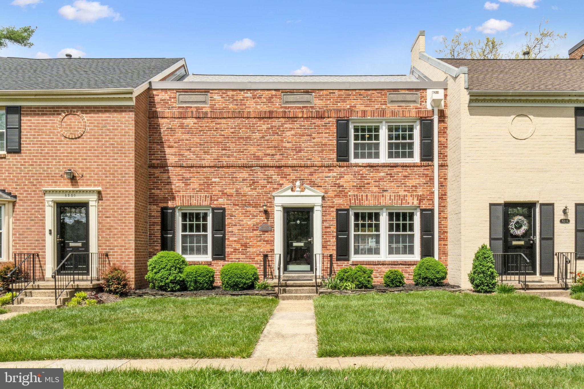 8248 Carrleigh Parkway Springfield, VA 22152 - Photo 1 of 45 front view of a brick house with a yard