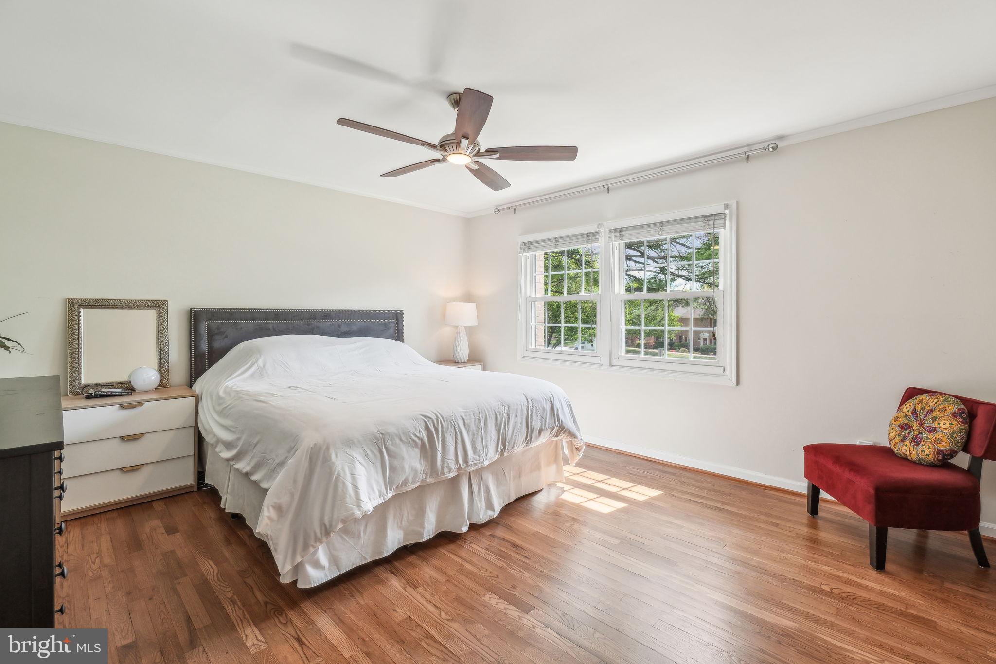 8248 Carrleigh Parkway Springfield, VA 22152 - Photo 13 of 45 a bedroom with a bed and wooden floor