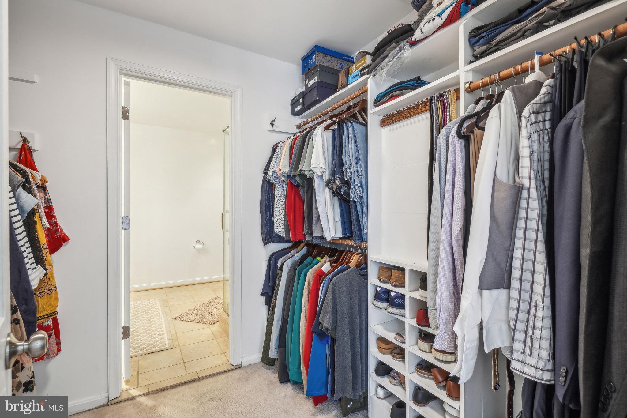 8248 Carrleigh Parkway Springfield, VA 22152 - Photo 15 of 45 a view of walk in closet with clothes and shoes