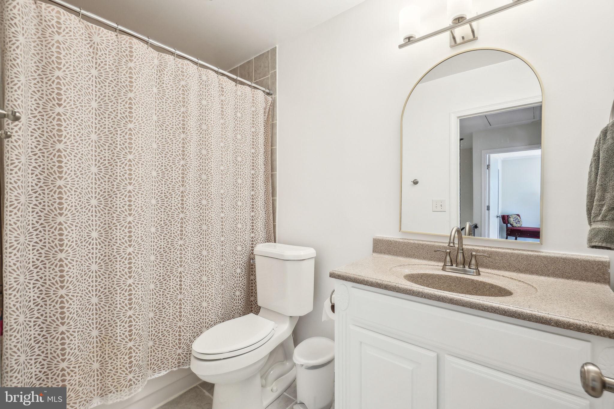 8248 Carrleigh Parkway Springfield, VA 22152 - Photo 21 of 45 a bathroom with a toilet a sink and a mirror