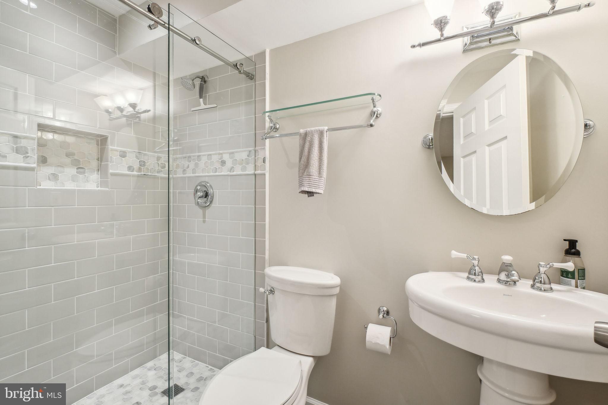 8248 Carrleigh Parkway Springfield, VA 22152 - Photo 26 of 45 a bathroom with a sink toilet and shower