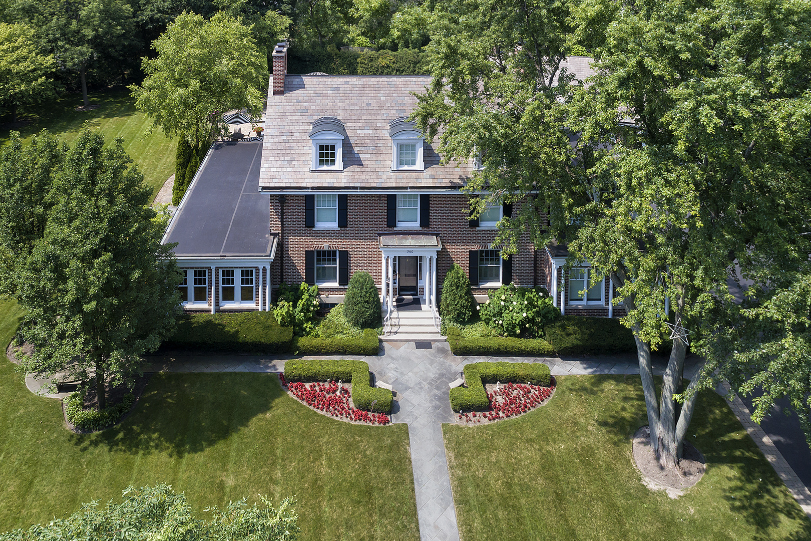 a front view of house with yard and green space