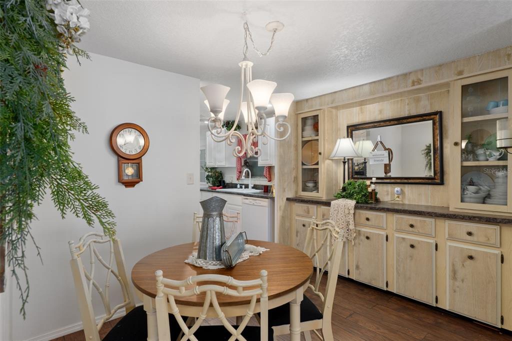 8197 Fiesta Street Brooksville, FL 34613 - Photo 11 of 49 a view of a dining room with furniture and wooden floor