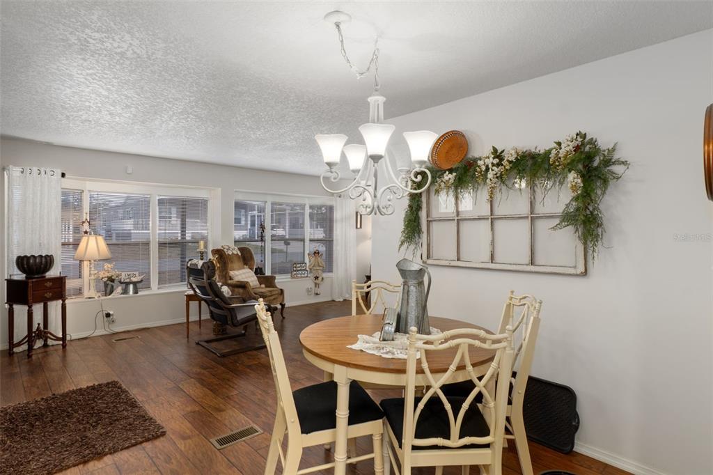8197 Fiesta Street Brooksville, FL 34613 - Photo 13 of 49 a view of a dining room with furniture and wooden floor