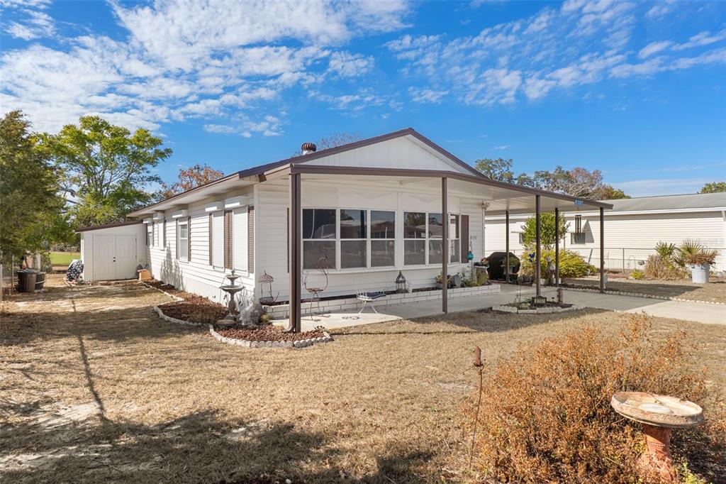 8197 Fiesta Street Brooksville, FL 34613 - Photo 2 of 49 a front view of a house with a yard