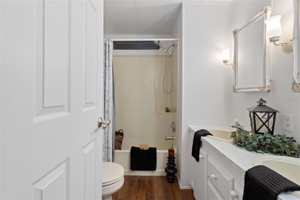 8197 Fiesta Street Brooksville, FL 34613 - Photo 31 of 49 a bathroom with a sink a toilet and a shower